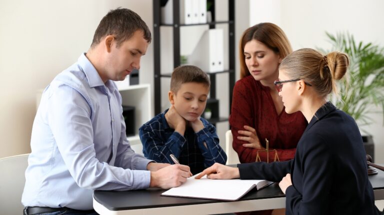 Divorced parents with their son visiting lawyer