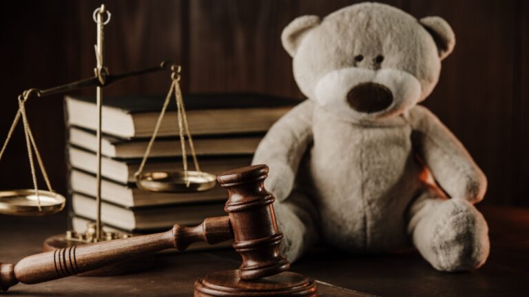 Wooden gavel and teddy bear